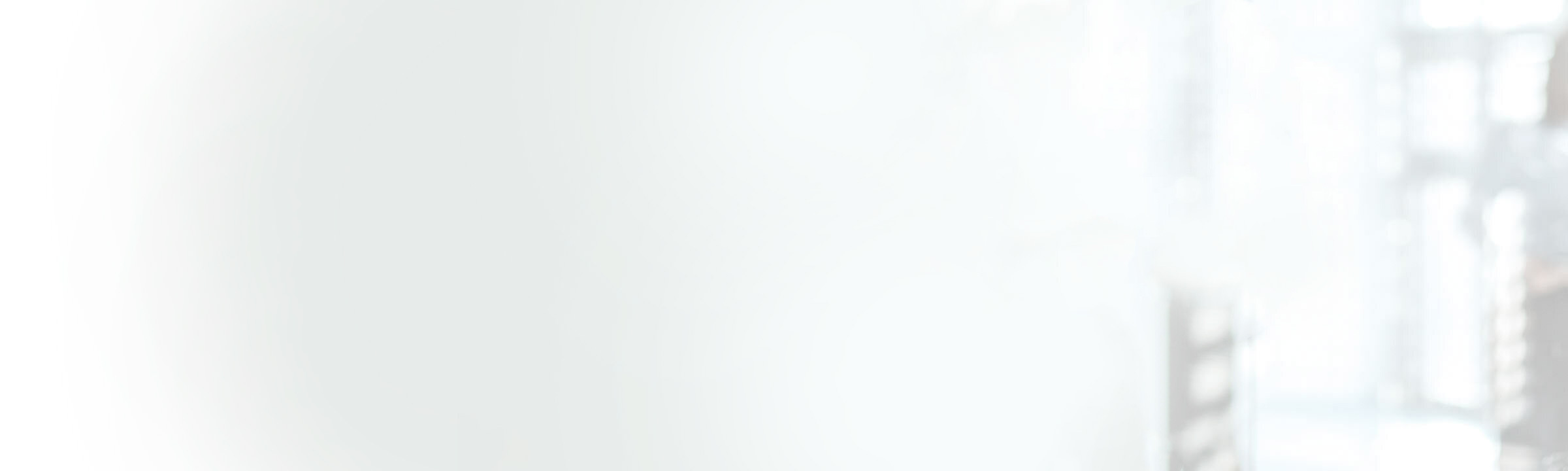 Blurry office background with a woman standing in the far right corner