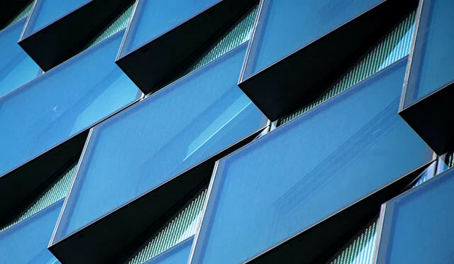 Exterior building design. Blue shingles close up