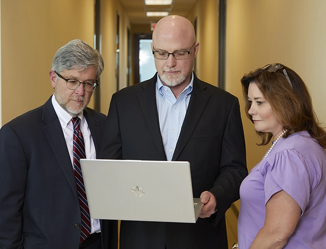 Three business people with computer