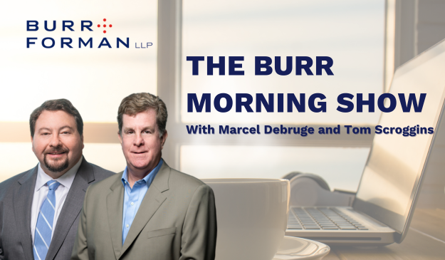The Burr Morning Show with Marcel Debruge and Tom Scroggins headshots appear in front of a computer screen, a steaming coffee mug, and a pair of headphones. The background also includes a view of the outside through a window.